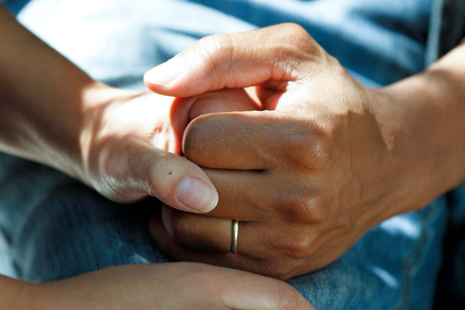 a family member holding a patient's hand