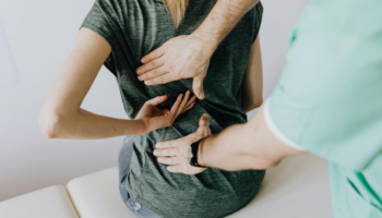 A spine specialist examining a patient’s back.