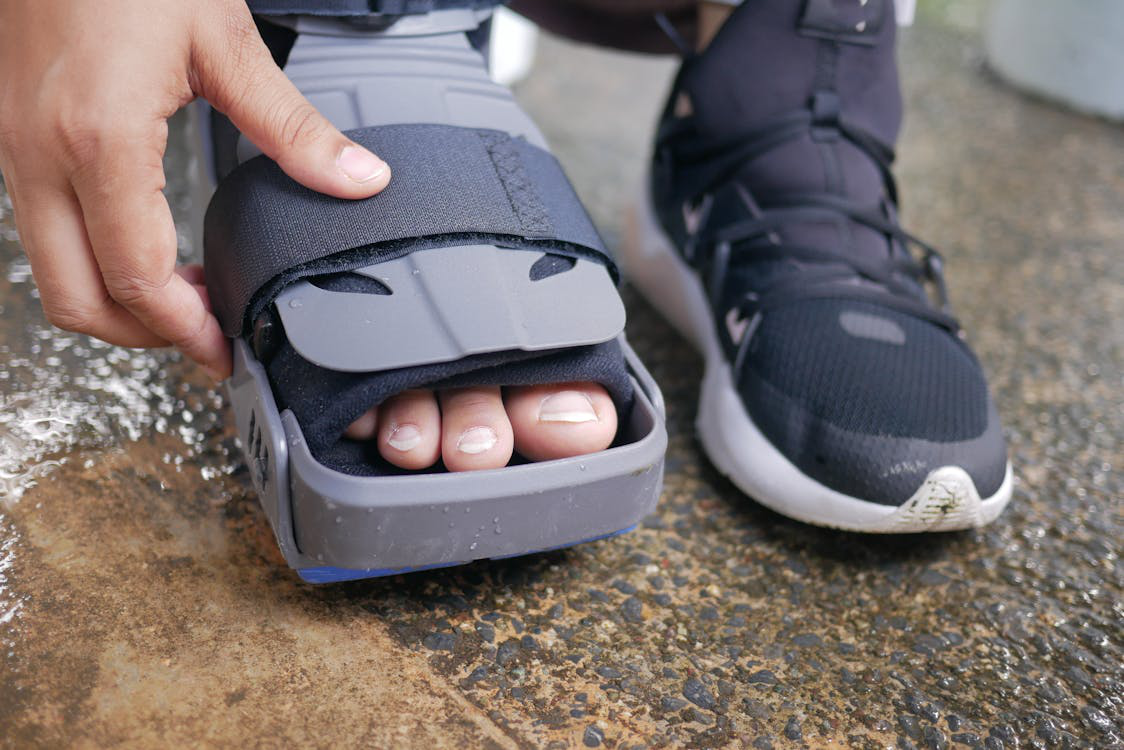 A person wearing a foot brace for support after a podiatry consultation.