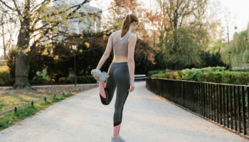 An athlete stretching and performing warm-up exercises.